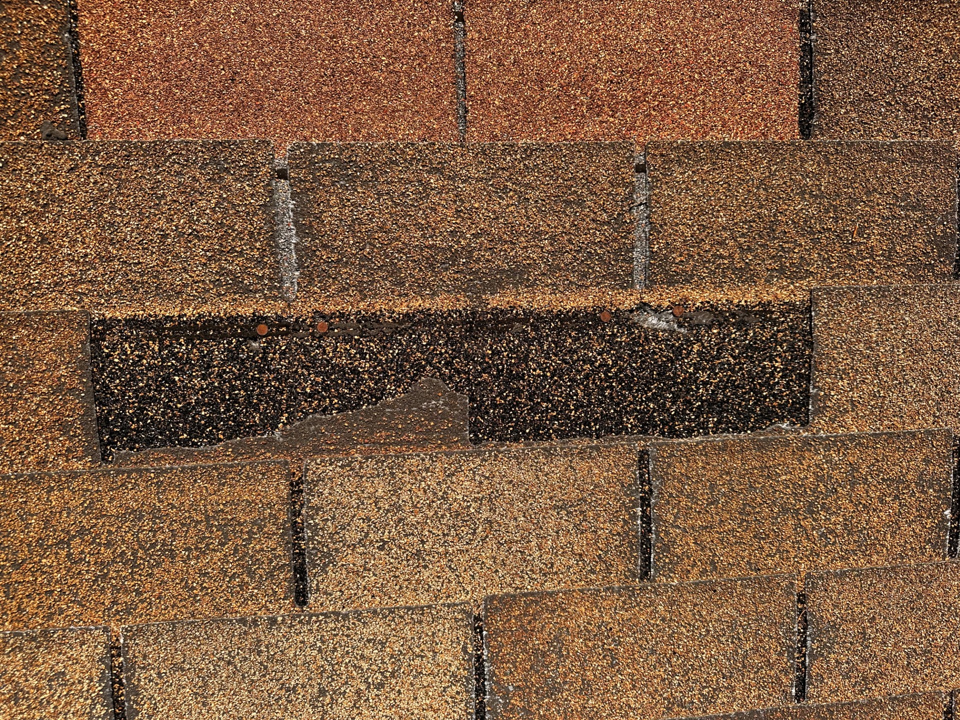 missing ashalt shingle blown off by wind. missing ashalt shingle blown off by wind.